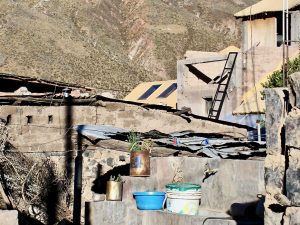 Blue skies and a hillside cross tower over Chivay, Peru